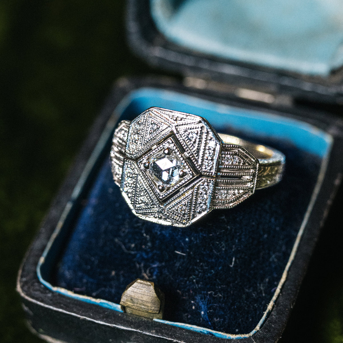 Custom 14k white and yellow gold filigree engagement ring with a rose-cut diamond in the center and brilliant-cut diamond accents.