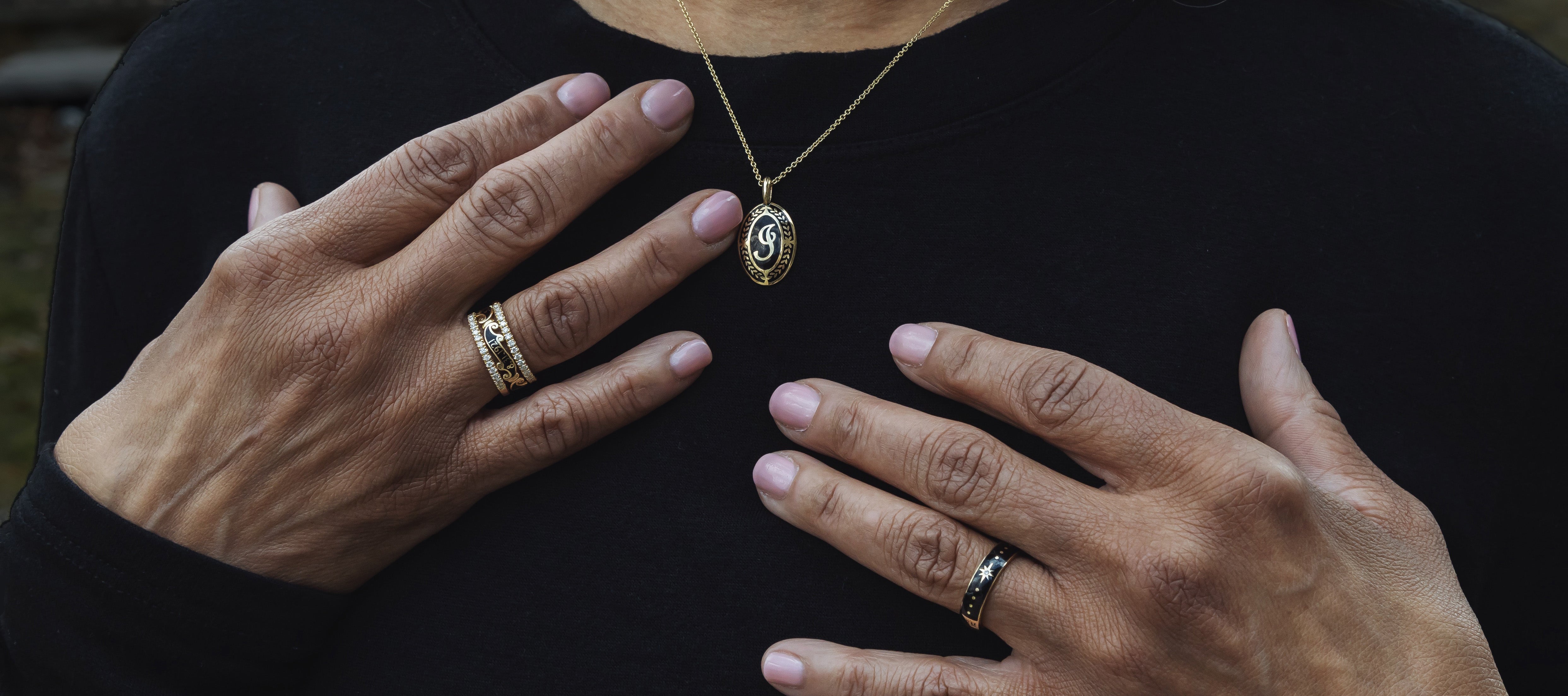 Person wearing gold oval memorial pendant